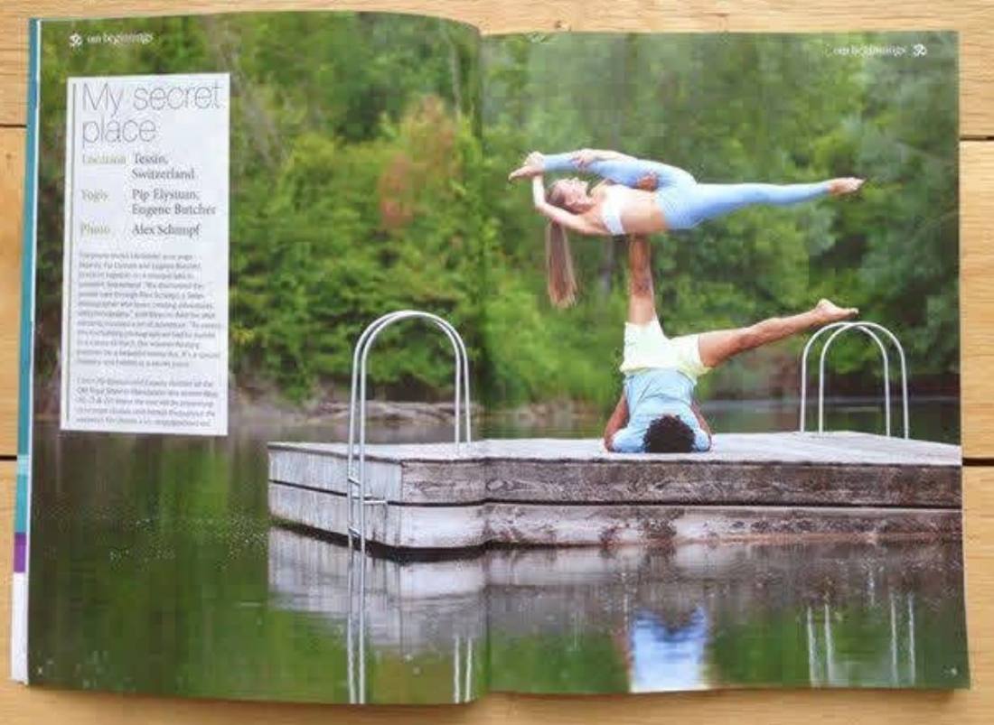 OM Yoga double page spread, My Secret Place, Pip in an acroyoga pose on a lakeside jetty in Switzerland